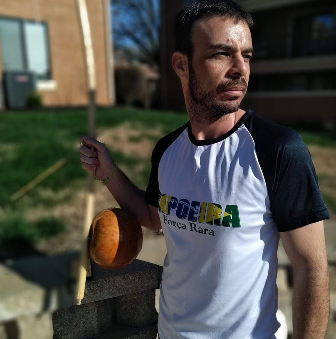 Professor Fedo holding a berimbau